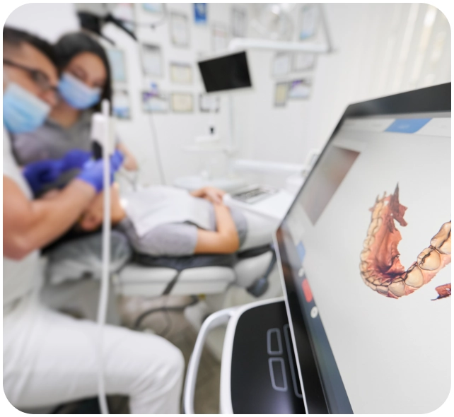 A patient in a dentist's chair receiving a digital dental scan.
